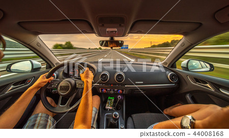 Driver's hands on a steering wheel of a car Driver's hands on a steering wheel of a car 44008168