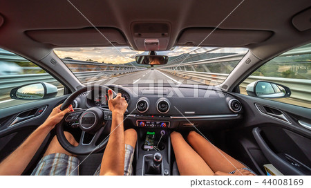 Driver's hands on a steering wheel of a car Driver's hands on a steering wheel of a car 44008169