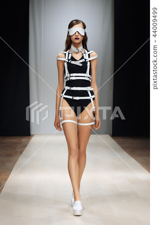 Fashion model in leather bondage on runway Fashion model in leather bondage on runway 44009499