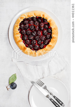 Homemade traditional plum galette on the plate Homemade traditional plum galette on the plate 44011361