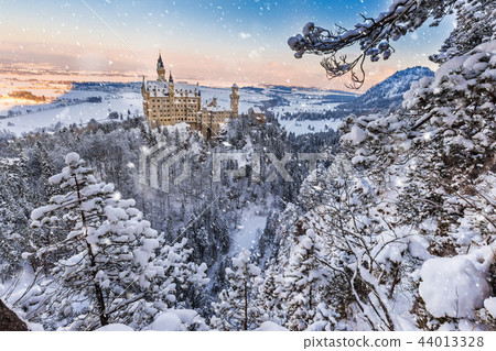 Neuschwanstein Castle during sunrise in winter landscape. Neuschwanstein Castle during sunrise in winter landscape. 44013328
