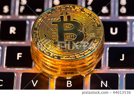 Bitcoin gold coins with laptop keyboard. Virtual cryptocurrency concept. Bitcoin gold coins with laptop keyboard. Virtual cryptocurrency concept. 44013536