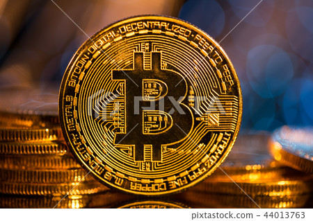 Bitcoin gold coins with defocused abstract background. Virtual cryptocurrency concept. Bitcoin gold coins with defocused abstract background. Virtual cryptocurrency concept. 44013763