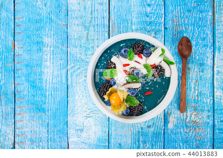 Smoothie bowl with fresh berries, nuts, seeds, fruit and vegetables. Smoothie bowl with fresh berries, nuts, seeds, fruit and vegetables. 44013883