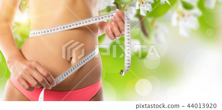 Woman with measure tape Woman with measure tape 44013920