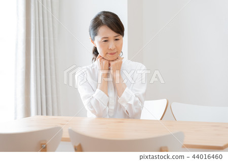 A woman holding down her chest 44016460