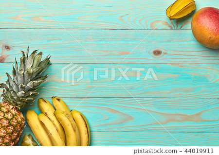 Mango, carambola, banana, pineapple on a blue wooden background with copy space. Tropical Fruits 44019911