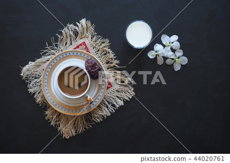 Black coffee and a glass of milk on the black Black coffee and a glass of milk on the black 44020761