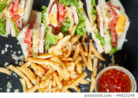 Delicious sandiwch with french fries and tasty red sos 44022244