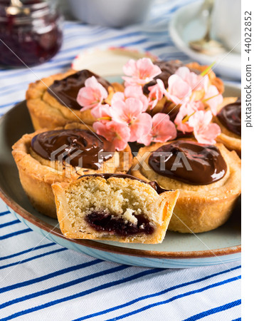 Cakes with frangipane, cherry jam and chocolate Cakes with frangipane, cherry jam and chocolate 44022852
