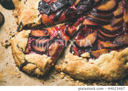 Plum galetta sweet cake dessert on baking paper, horizontal composition 44025467