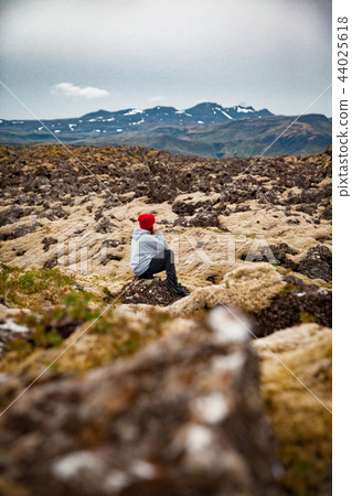 Woman at mossy stones in Iceland 44025618