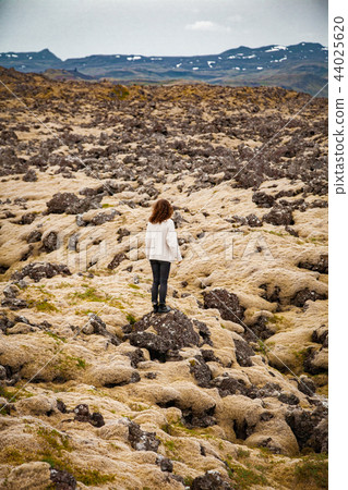 Woman at mossy stones in Iceland Woman at mossy stones in Iceland 44025620