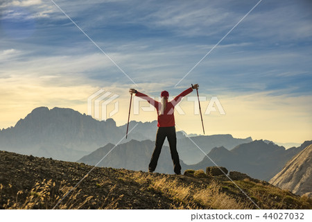 Sporty Young woman on mountain trail Dolomites Mountains, Italy 44027032