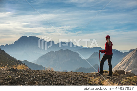 Sporty Young woman on mountain trail Dolomites Mountains, Italy 44027037