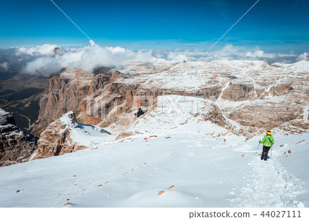 Tourist hiking in mountains Sella Ronda 44027111