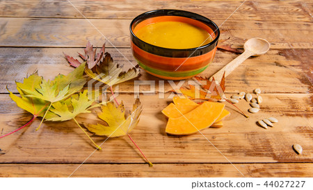pumpkin soup bowl on rustic wooden background pumpkin soup bowl on rustic wooden background 44027227