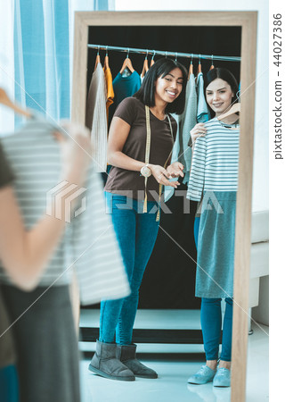 Cheerful international woman actively gesticulating 44027386