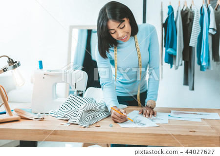 Delighted young woman drawing sketch Delighted young woman drawing sketch 44027627