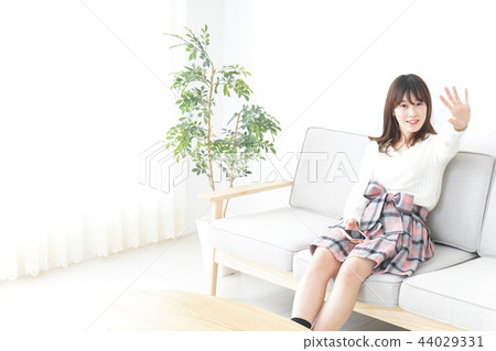 A woman using a personal computer at home A woman using a personal computer at home 44029331