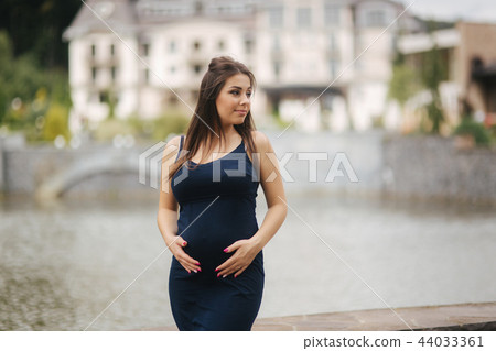 Young beautiful pregnant woman standing near the lake 44033361