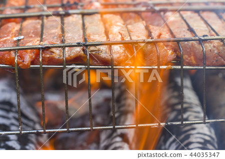 raw meat steak fry on fire 44035347