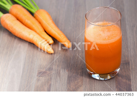 A glass of healthy carrot smoothie with carrots 44037363