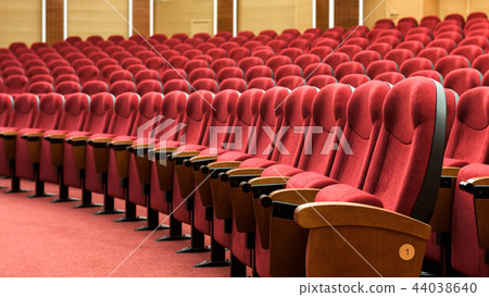 Rows of red theater seats 44038640