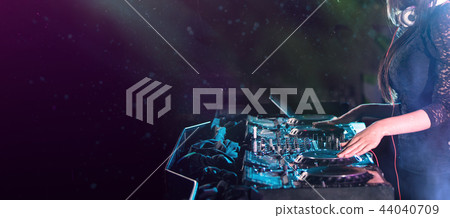 Dj mixes the track in the nightclub at a party Dj mixes the track in the nightclub at a party 44040709