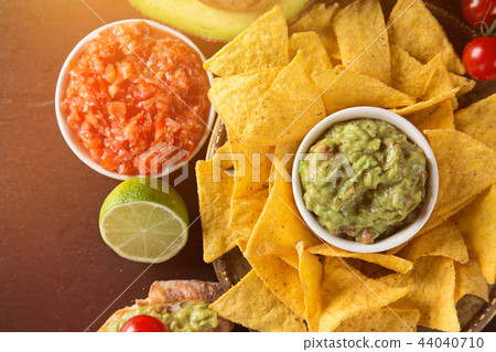 Tradition mexican guacamole and salsa dip, nachos tortilla chips. 44040710