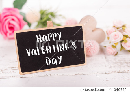 Small chalkboard for Valentine's day. Background with pink roses. 44040711