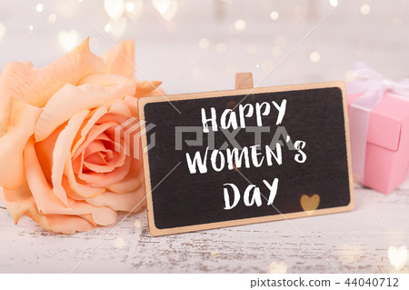 Small chalkboard for Women's day. Background with pink roses. Small chalkboard for Women's day. Background with pink roses. 44040712