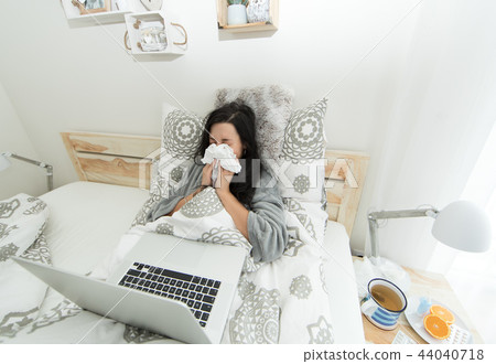 Young woman having flu, blowing her nose. Young woman having flu, blowing her nose. 44040718