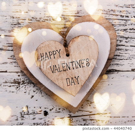 Heart composition for Valentine Day. Wooden hearts on old white desk. 44040740