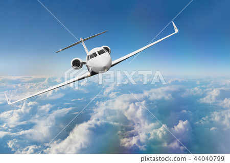 Commercial airplane flying above clouds. 44040799