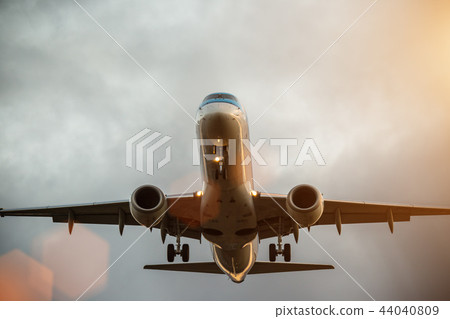 Commercial airplane flying above clouds. 44040809