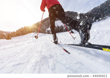 Man cross-country skiing during sunny winter day. 44040821