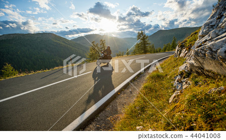 Motorcycle driver riding in Alpine highway, Nockalmstrasse, Austria, Europe. 44041008