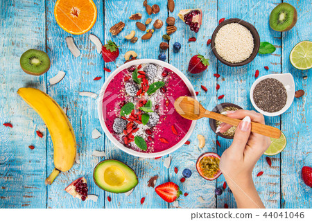 Smoothie bowl with fresh berries, nuts, seeds, fruit and vegetables. 44041046