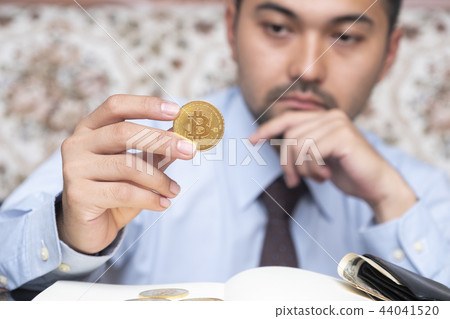 Businessman holding bitcoin. Crypto currency Businessman holding bitcoin. Crypto currency 44041520