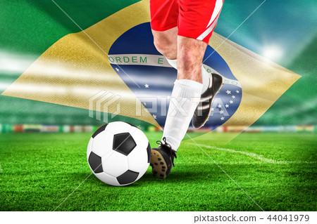Composite image of football player in white kicking 44041979