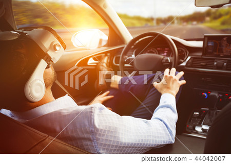 man behind the wheel wearing a virtual reality helmet 44042007