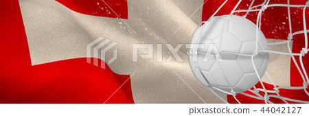 Composite image of soccer ball in goal net 44042127