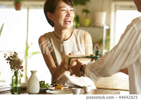 A couple giving gifts A couple giving gifts 44042825