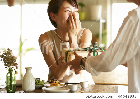 A couple giving gifts A couple giving gifts 44042933