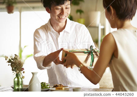 A couple giving gifts A couple giving gifts 44043260