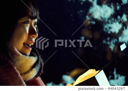 A woman with a present A woman with a present 44043267