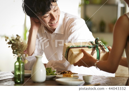 A couple giving gifts A couple giving gifts 44043332