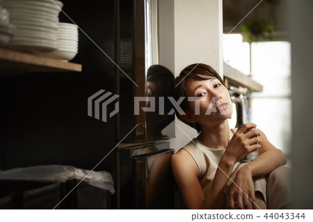 Woman drinking alcohol in a room Woman drinking alcohol in a room 44043344