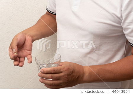 Middle-aged man taking medicine 44043994